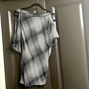 Semi sheer, cropped shoulder with button to transform shirt. In great condition